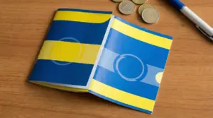 Libretti postali su un tavolo con alcune monete e una penna